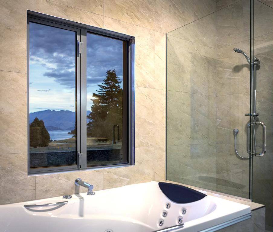 The King Room with Spa Bath, looking out over the gardens toward the lake